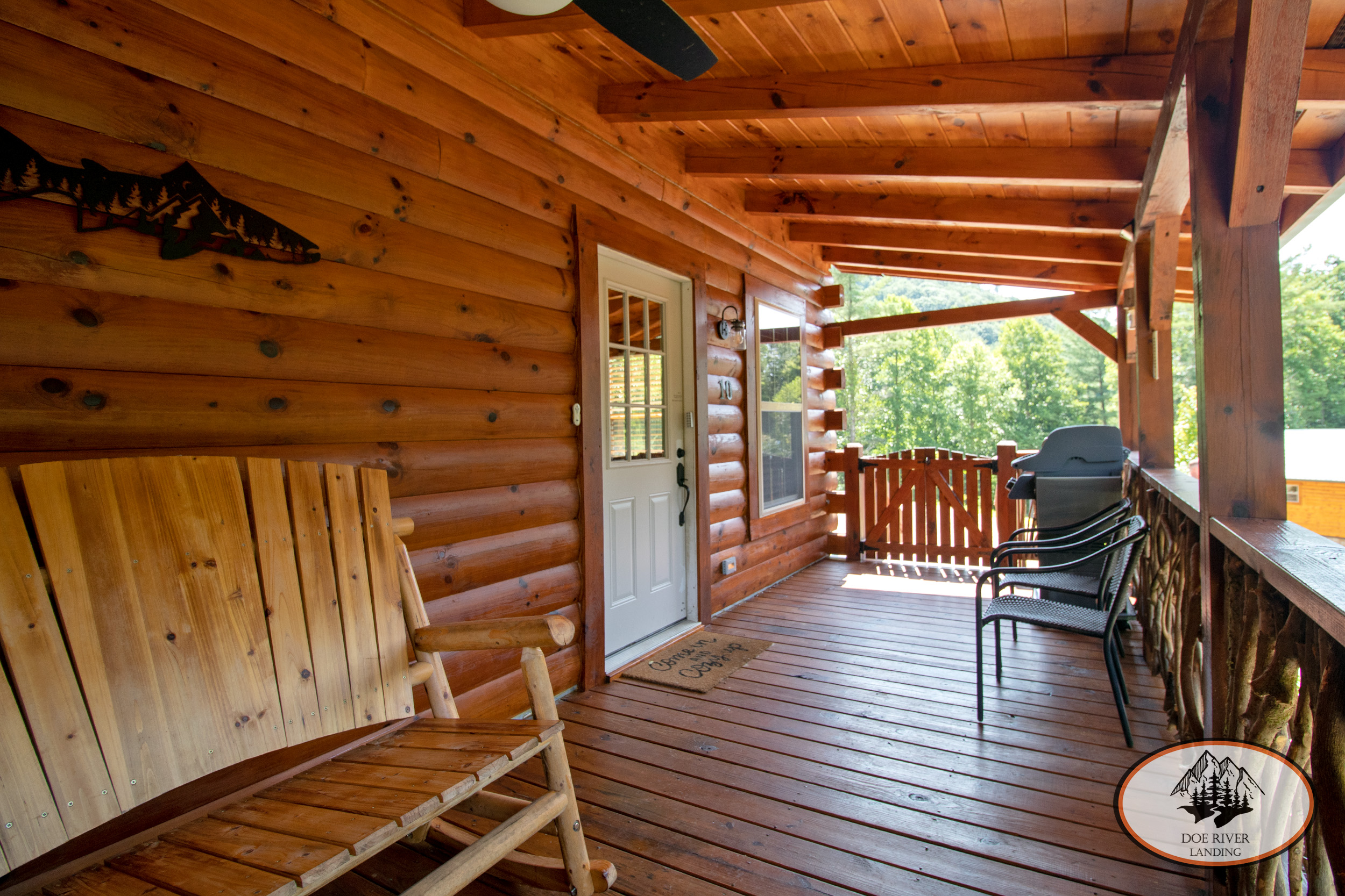 Doe River Landing campground in Roan Mountain, TN. Best vacation rental near Elizabethton, TN and Johnson City TN. Big Bear Cabin luxury cabin rental features a large porch, grill, private picnic area with umbrella, hot tub, and an amazing view of Roan Mountain forest.