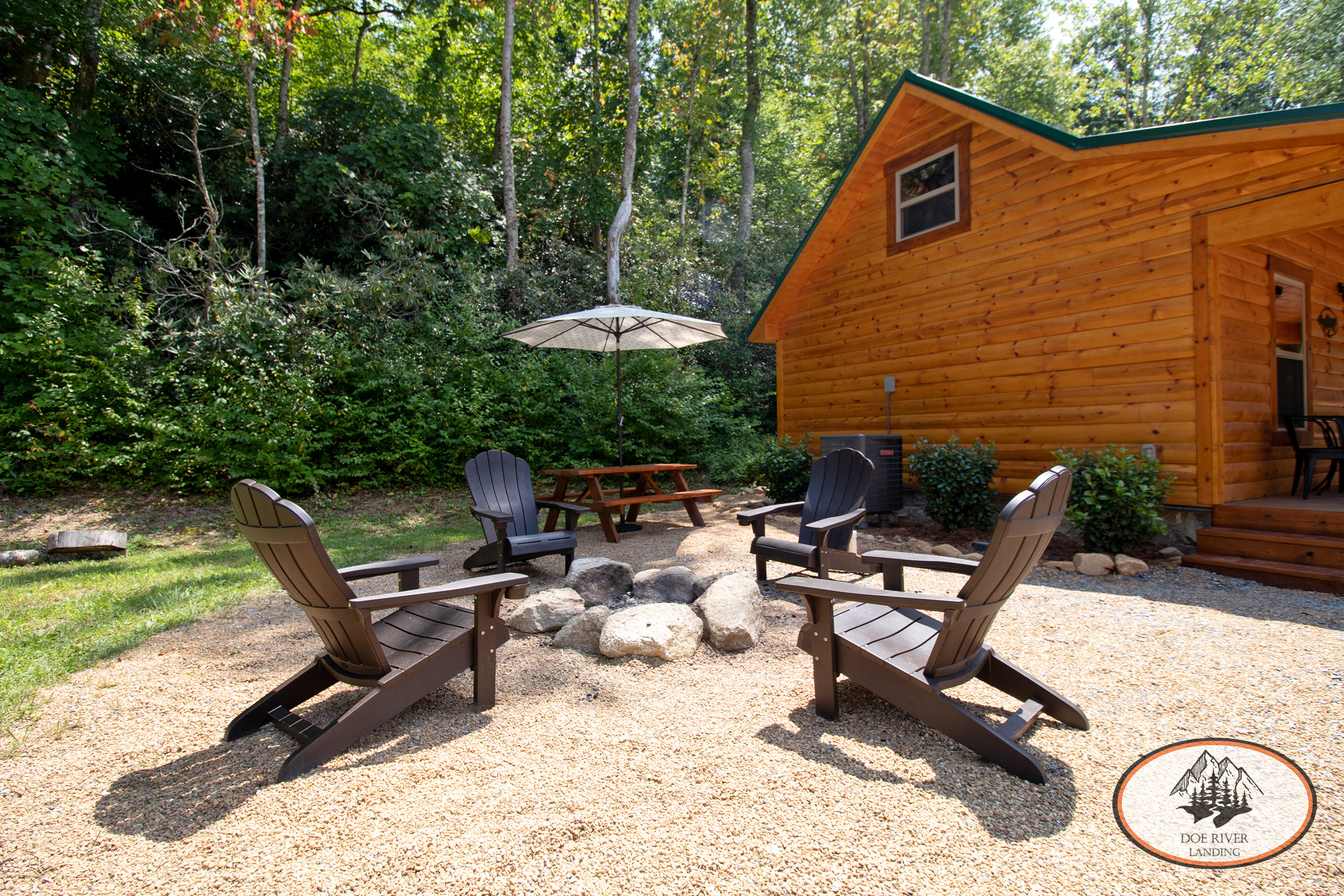 Doe River Landing campground in Roan Mountain, TN. Best vacation rental near Elizabethton, TN and Johnson City TN. Trout Cabin private riverside campsite with fire pit, picnic table, grill, and umbrella.